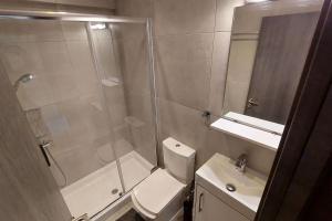 a bathroom with a shower and a toilet and a sink at Limassol Molos Hawaii Royal - Front-line 2 bedroom in Limassol +10 photos