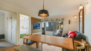 a living room with a table and a couch at Shamrock 1 in Mount Hotham