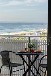 a table and chairs on a balcony with a view of the beach at Trapani beach in Casa Santa