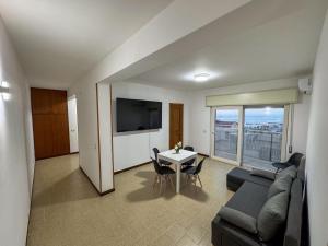 a living room with a couch and a table at Trapani beach in Casa Santa