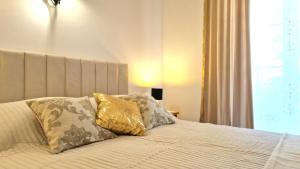 a bedroom with a bed with two pillows on it at Avalena Rooms in Zadar