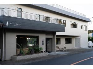 a white building with a bench in front of it at HOTEL FARO manazuru - Vacation STAY 56464v in Manazuru