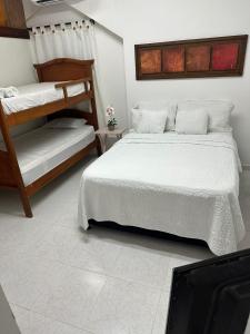 ein Schlafzimmer mit zwei Etagenbetten und einem Fernseher in der Unterkunft Apartaestudio en el Centro in Cartagena de Indias