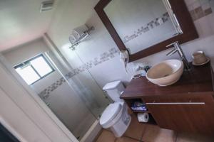a bathroom with a shower and a sink and a toilet at Suite Privada en Coronado Luxury Club & Suites in Playa Coronado