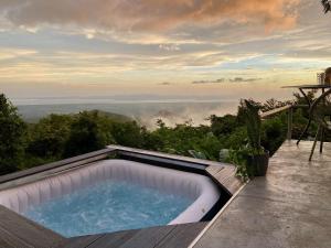 a hot tub on a deck with a view at Domos Mirador Romantic Private Honeymoon Glamping in Miramar