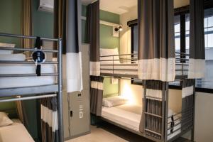 a room with bunk beds in a hostel at Stay Wanglang in Bangkok