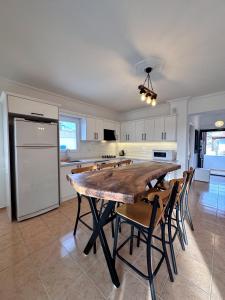 a kitchen with a large wooden table and chairs at Wonderful Sunset 1 in Bodrum City +10 photos
