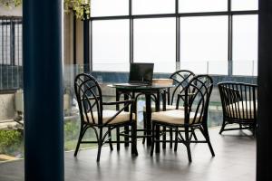 a table and chairs with a laptop on it at Stay Wanglang in Bangkok