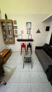a living room with a couch and a table at check in hotel in Brinchang