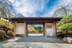a building with a gate with a statue in it at Yoshimatsu in Hakone +37 photos