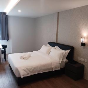 Postel nebo postele na pokoji v ubytování Soho Tabuan Kuching + 6 fotografií