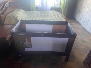 a bed with a box on top of it at Stefania's house in Agia Effimia