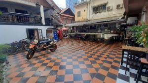 a motorcycle parked on a checkered floor in a building at Vientiane Star Hotel in Vientiane