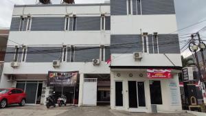 a building with a red car parked in front of it at Safa Kost and Homestay in Ngadipuro