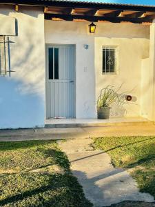 a white house with a door and a window at Casita Larraun- tu espacio cálido en la tranquilidad de Navarro in Navarro