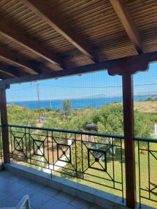 a balcony with a view of the ocean at Tasos in Nea Potidaea