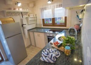 a kitchen with a counter with fruits and vegetables on it at Kuća za odmor Brigitaa in Jezera