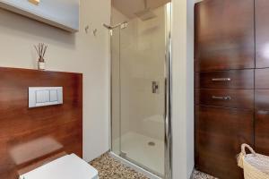a shower with a glass door in a bathroom at Willa Morska Deluxe by Grand Apartments in Sopot +10 photos
