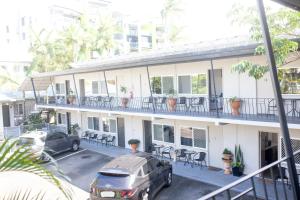 an apartment building with cars parked in a parking lot at Cairns City Motel in Cairns