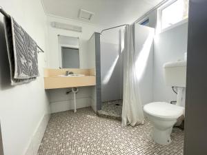 a bathroom with a toilet and a sink at Cairns City Motel in Cairns +35 photos