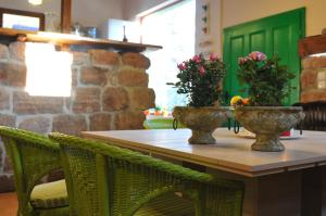 a table with two vases with flowers on it at Villa Kada in Belogradchik