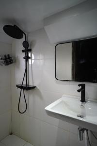 a bathroom with a mirror and a sink at Floating Hotel in Uluwatu SALTWATER COWBOYS in Bingin Beach