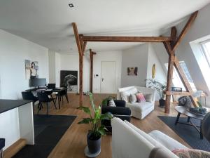 a living room with a couch and a table at Luxus Penthouse Waterview in Kiel