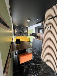 a kitchen with a table with an orange chair at Chambre d hôte lac du Der orconiat in Orconte