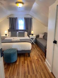 Un dormitorio con una cama grande y un sofá. en Your Home Away from Home - Jamaica Plain, Boston, en Boston