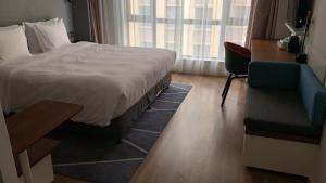 Postel nebo postele na pokoji v ubytování Holiday Inn Express Zhangjiagang East by IHG