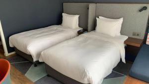 Postel nebo postele na pokoji v ubytování Holiday Inn Express Zhangjiagang East by IHG