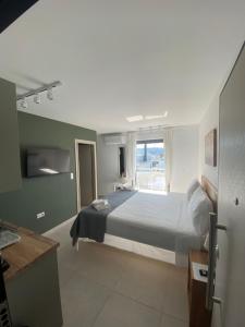 a bedroom with a large bed and a window at Aphrodite Suite byArtistUnknown in Vari