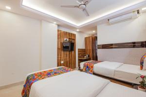 Postel nebo postele na pokoji v ubytování FabHotel SG5 Inn Suites-Yelahanka