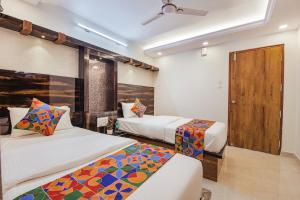 Postel nebo postele na pokoji v ubytování FabHotel SG5 Inn Suites-Yelahanka
