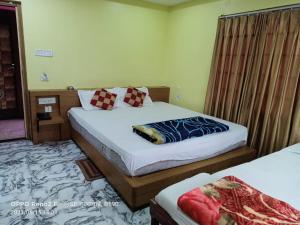 a bedroom with two beds in a room at Hotel Royal Paradise ! New Digha in Digha +20 photos