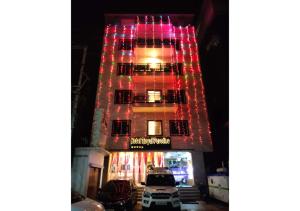 a tall building with christmas lights on it at Hotel Royal Paradise ! New Digha in Digha