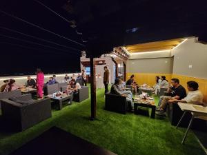a group of people sitting at tables in a room at The Clove Ladakh in Leh