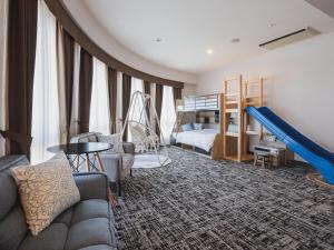 a living room with a couch and a slide at Gran Palette Hakodate in Hakodate
