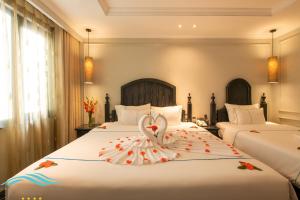 Voodi või voodid majutusasutuse Hanoi Emerald Waters Hotel Valley toas