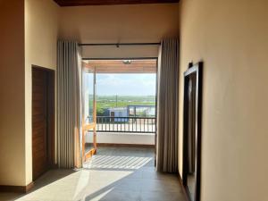 a hallway with a door open to a balcony at Liyadi Addalaichenai in Addalachenai