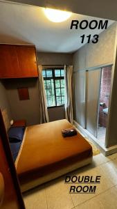 a bed in a room with a double room at check in hotel in Brinchang