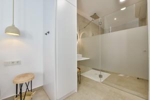 a bathroom with a shower and a stool at MIMAR ALTEA ROOMS - Tranquil in Altea