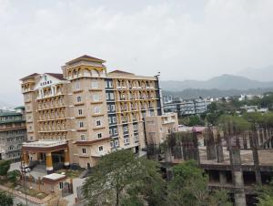 a large building in a city with buildings at Hotel Livbox in Dehradun