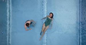a man and a woman on a water slide at MANNI das Hotel in Mayrhofen