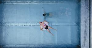a man swimming in a pool in the water at MANNI das Hotel in Mayrhofen