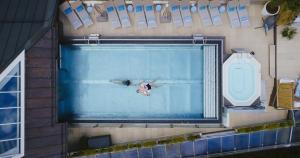 a person swimming in a swimming pool at MANNI das Hotel in Mayrhofen
