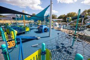 a park with a playground with slides and rides at Near Park Circle, Downtown, And Beaches in Charleston
