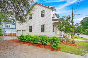 a white house on a street with bushes at Near Park Circle, Downtown, And Beaches in Charleston