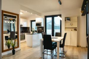 a kitchen and dining room with a table and chairs at Pension 1310 in Mladá Boleslav