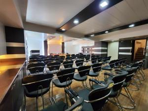 an empty room with chairs and tables in it at Hotel Surya Shimla in Shimla